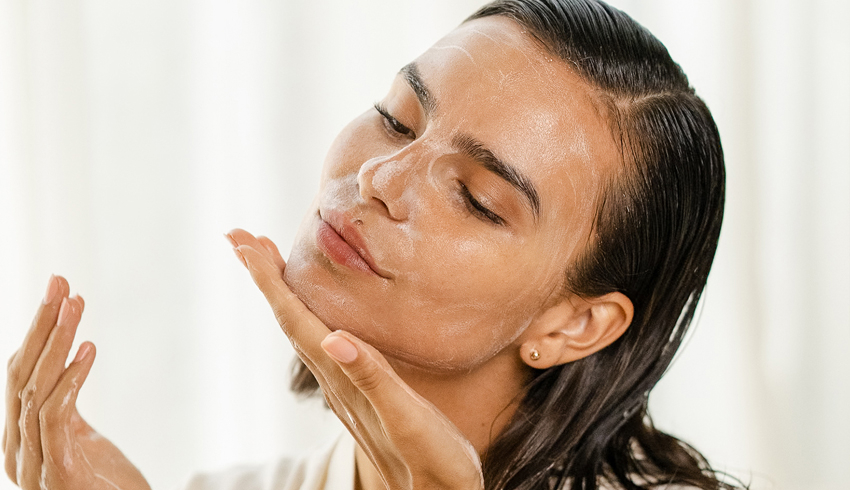 A woman cleansing her face