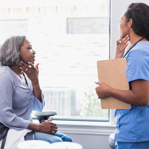 A woman checking her face after treatment