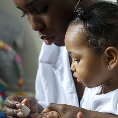 a mom giving her young daughter a manicure