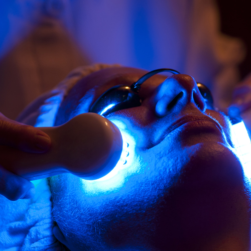 A woman in spa receiving LED facial