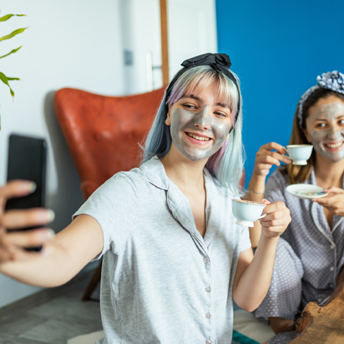 Girls with facial masque and drinking tea