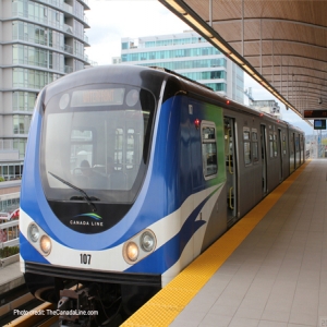 Light rail train cars pull into a stop