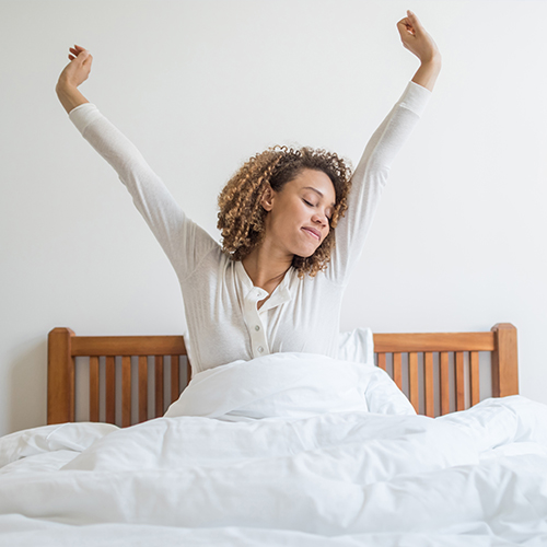 a woman waking up and stretching