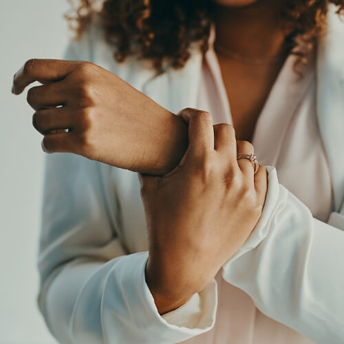 woman holding her aching wrist