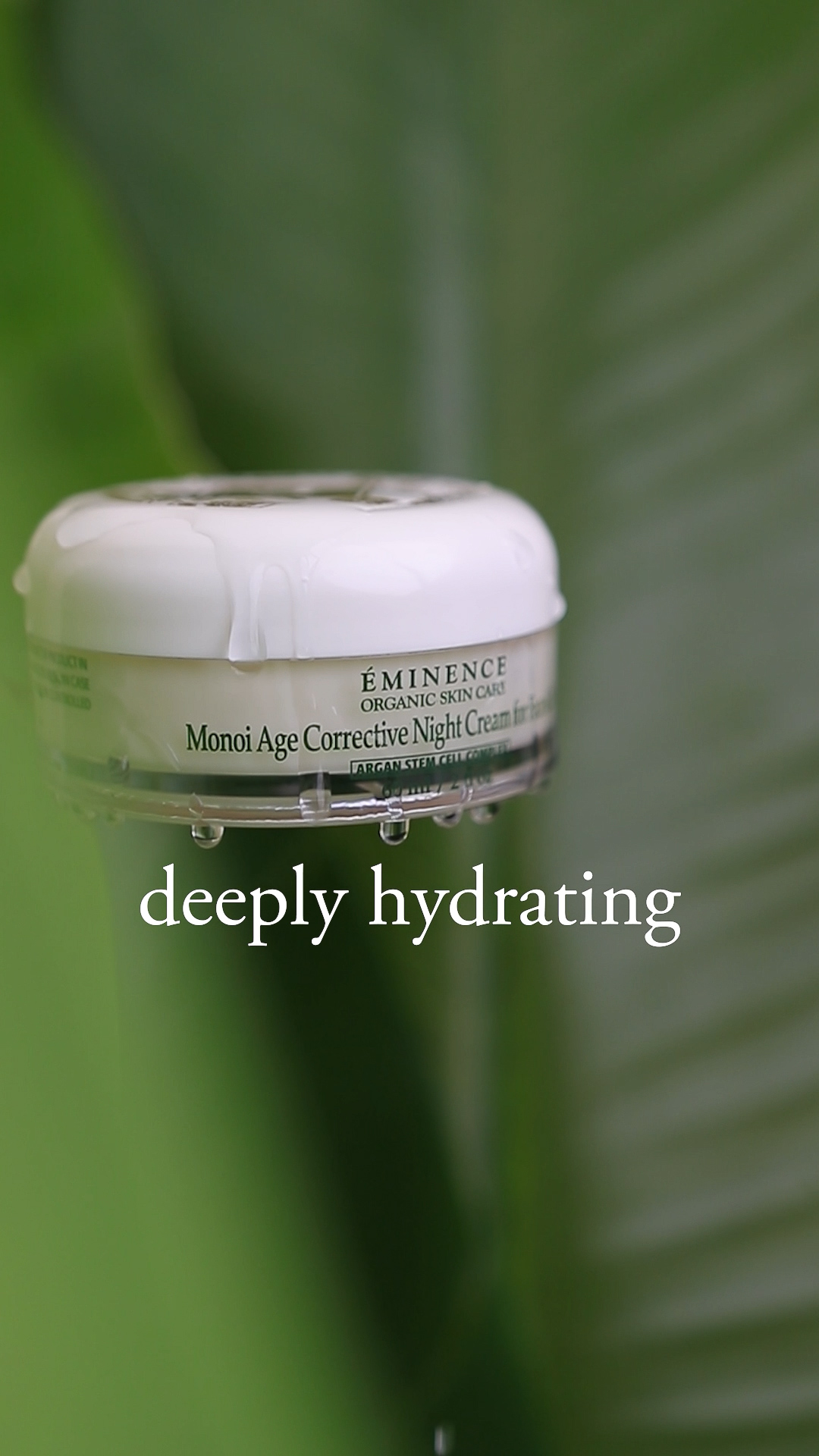 The Eminence Organics Monoi Age Corrective Night Cream for Face & Neck jar next to some plants
