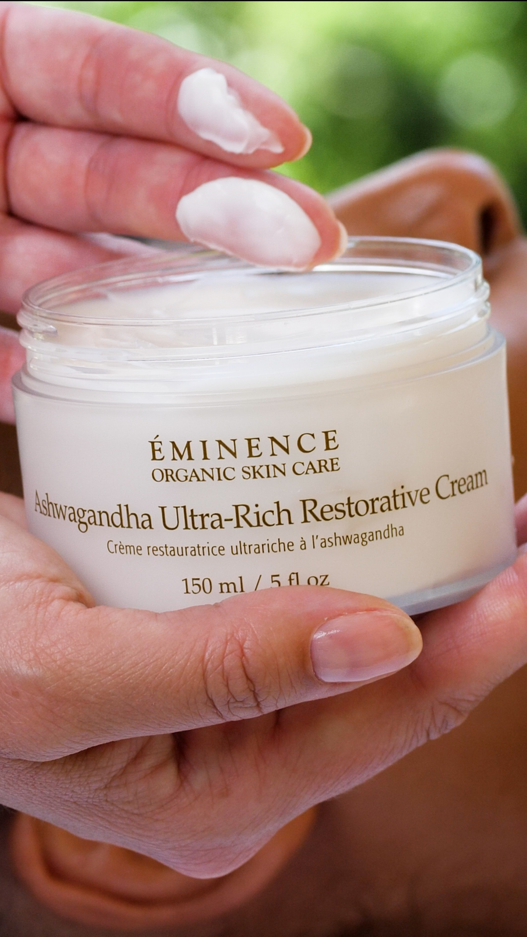 Eminence Organics Ashwagandha Ultra-Rich Restorative Cream  A woman holding the Eminence Organics Ashwagandha Ultra-Rich Restorative Cream